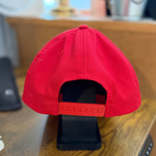 Load image into Gallery viewer, Red cap on a wooden surface with a blurred background